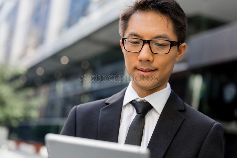 Similar – Image, Stock Photo Businessman enjoying coffee and checking his mobile phone for messages with a smile with his laptop and tablet open on the table