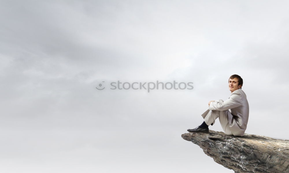 Similar – Man relaxing on cliff