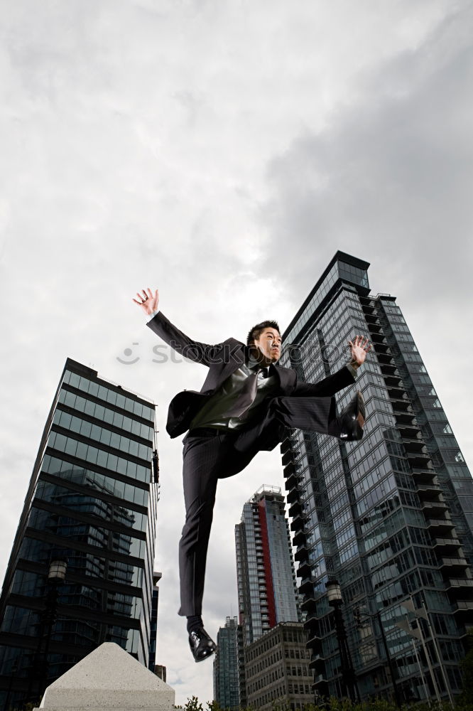 Similar – Woman jumps barefoot on blue rubber hills into the air with outstretched arms