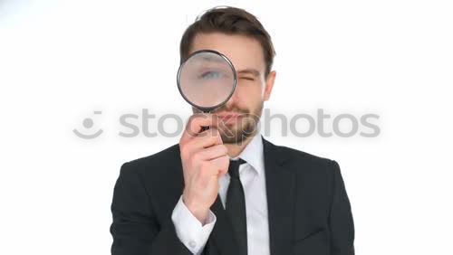 Similar – The man looking through a magnifier with suspicious