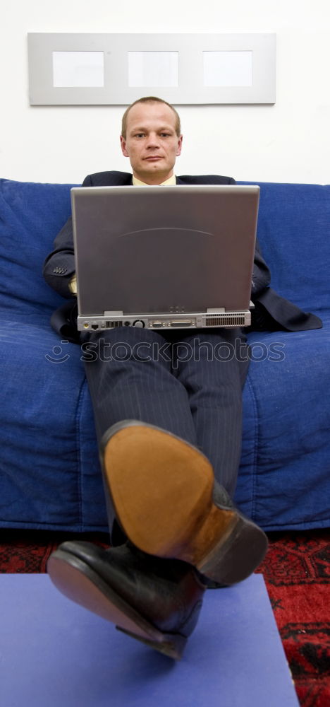 Similar – Relaxed boy holding smartphone sitting in chair at home