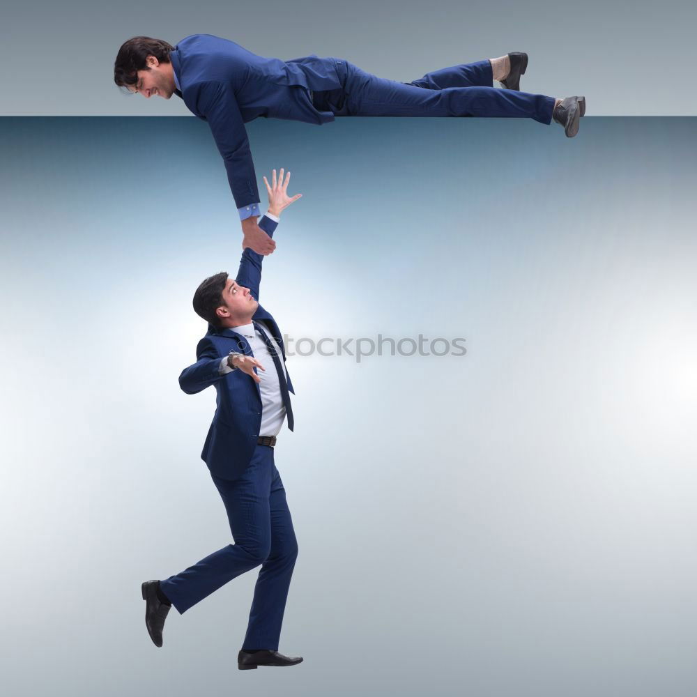 Two businessmen shaking hands in the air