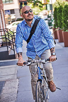 Similar – Handsome afro man walking with his bike.