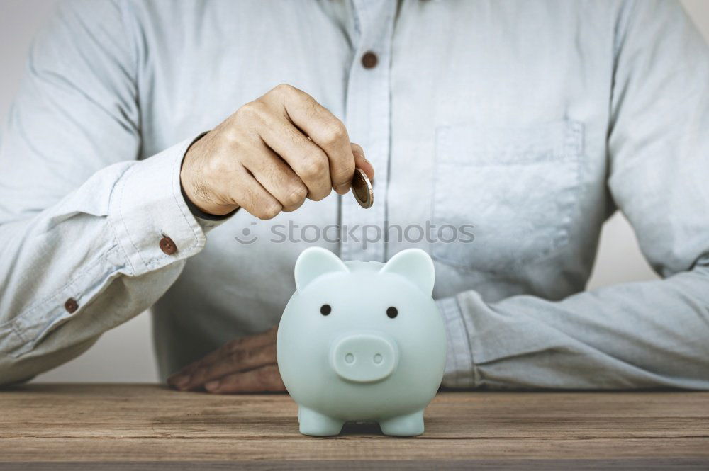 Similar – Image, Stock Photo Unhappy man angry at his piggy bank