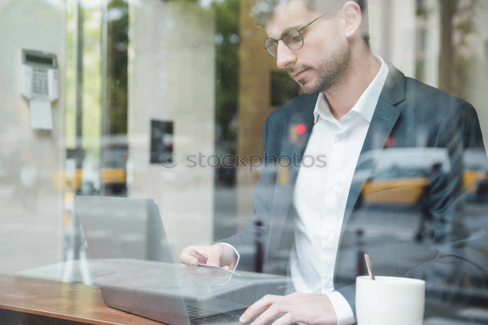 Similar – Geschäftsmann mit Blick auf das Smartphone im modernen Firmenbüro.