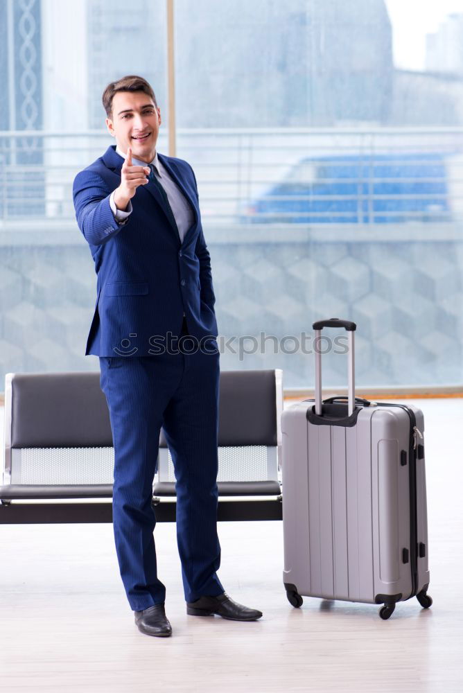 Similar – Image, Stock Photo Young business man standing with the suitcase at the airport waiting for the flight