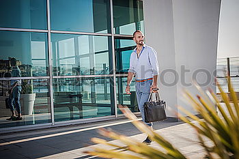 Similar – Image, Stock Photo man sitting at the airport using laptop and mobile phone next to the window