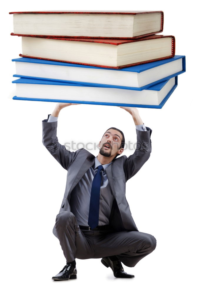 Similar – Man in book pile reading a book