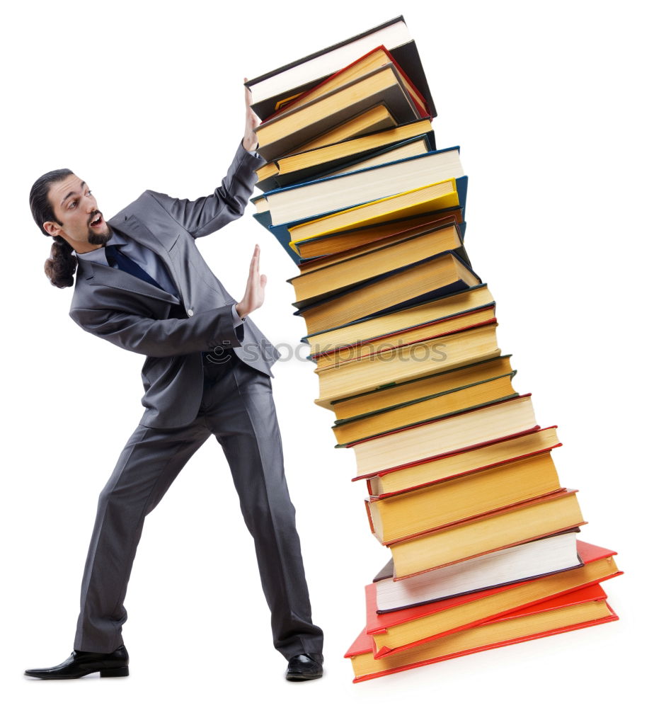 Similar – Man in book pile reading a book