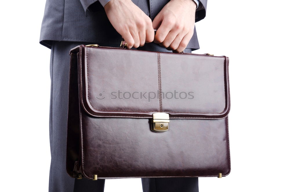 Similar – one person holds a leather travel bag in his hand