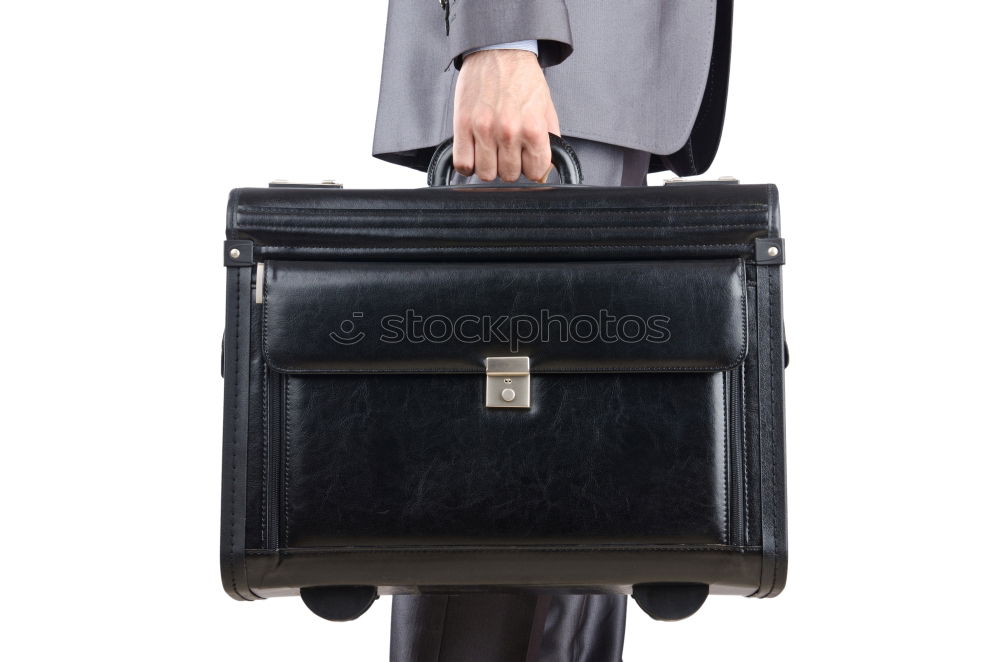 Similar – one person holds a leather travel bag in his hand