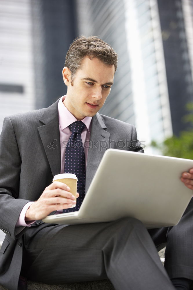 Similar – Image, Stock Photo Businessman enjoying coffee and checking his mobile phone for messages with a smile with his laptop and tablet open on the table