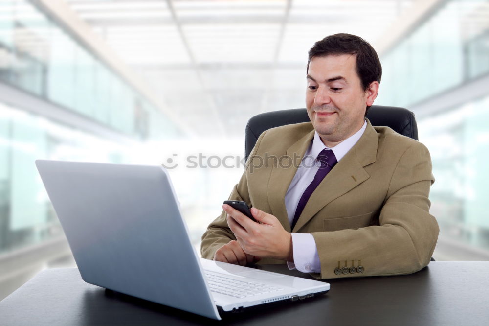 Similar – Image, Stock Photo Businessman enjoying coffee and checking his mobile phone for messages with a smile with his laptop and tablet open on the table