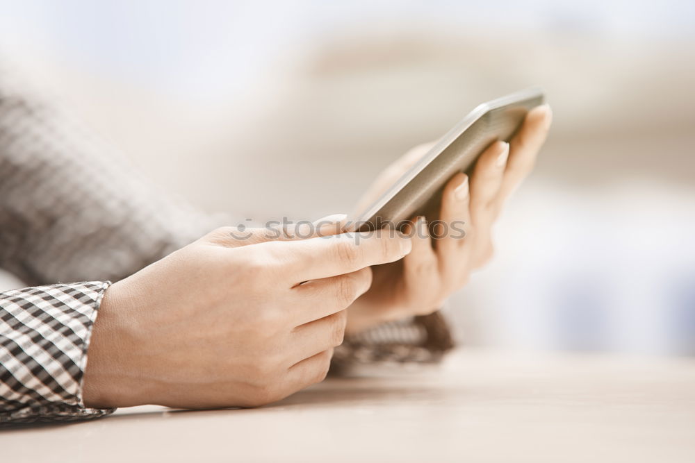 Similar – Woman hands using smartphone and writing notebook