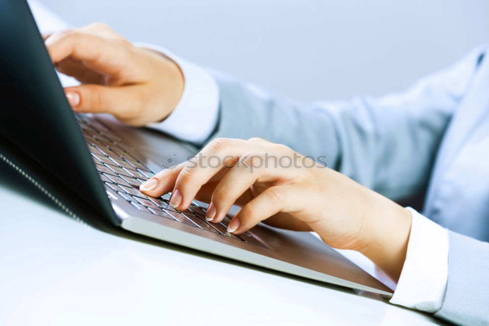 Similar – Young man works on a laptop in the start-up and listens to music through in-ear headphones