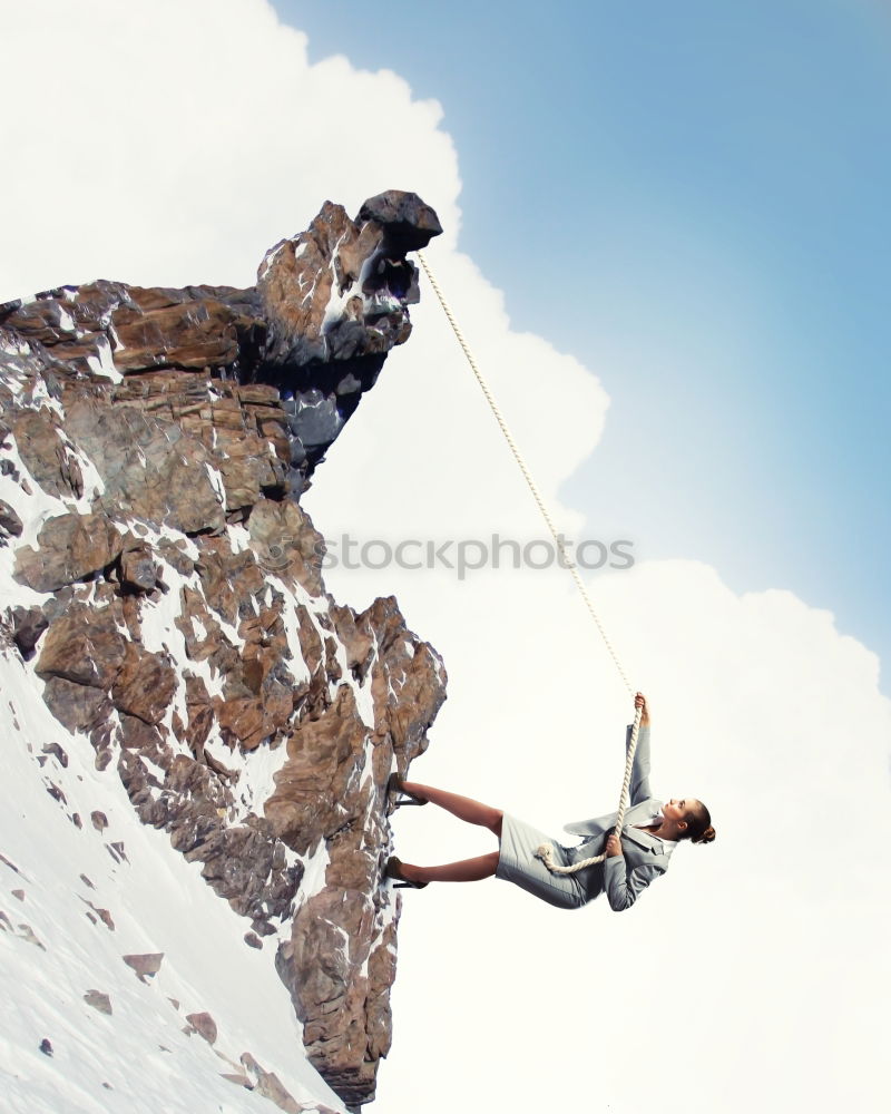 Similar – Image, Stock Photo Anonymous climber handing on cliff