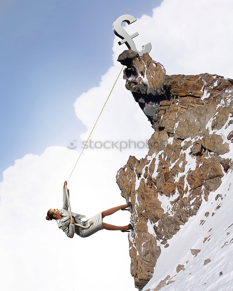 Similar – Rock climbing team reaching the summit.