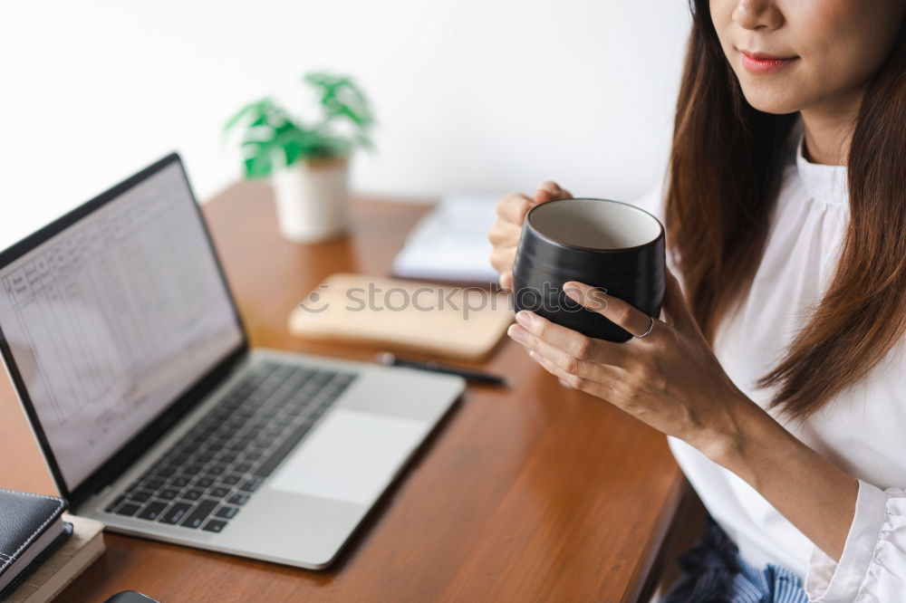 Similar – Young adult woman working on laptop in cafe