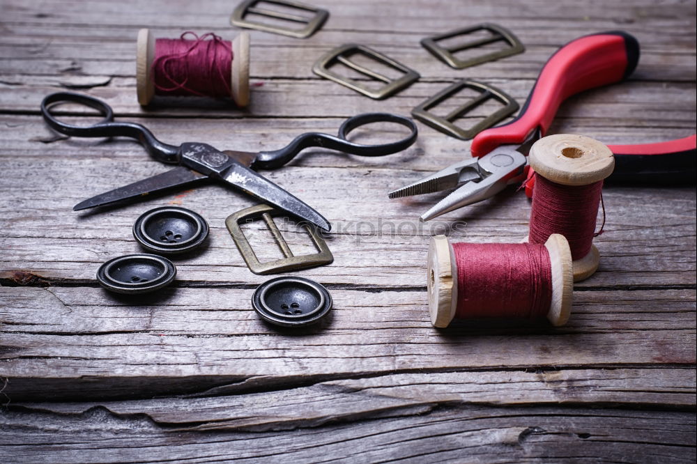 Similar – Image, Stock Photo Threaded in red: Sewing equipment, such as needle, thread, thimble wool, crochet hook and a needle cushion on a wooden table