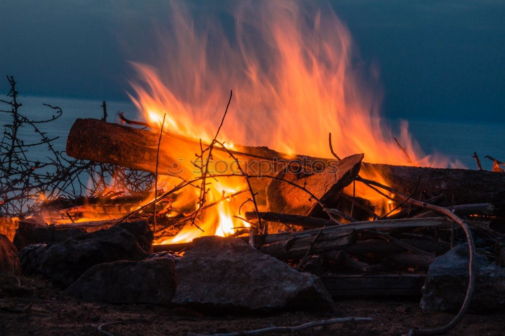 Similar – Image, Stock Photo Man lights a fire in the fireplace in nature at night