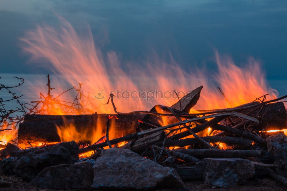 Similar – Man lights a fire in the fireplace