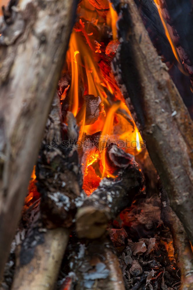 Similar – Ein großer Kochtopf hängt über offenem Feuer einer Feuerschale.