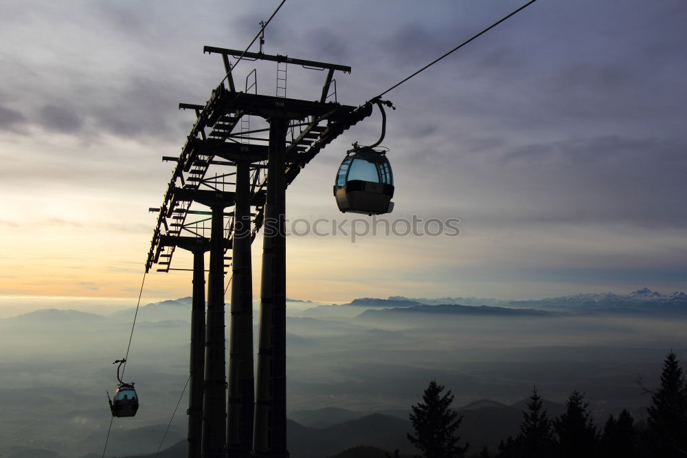 Similar – Chairlift with empty 2-seater chair and view of snow-free hill country