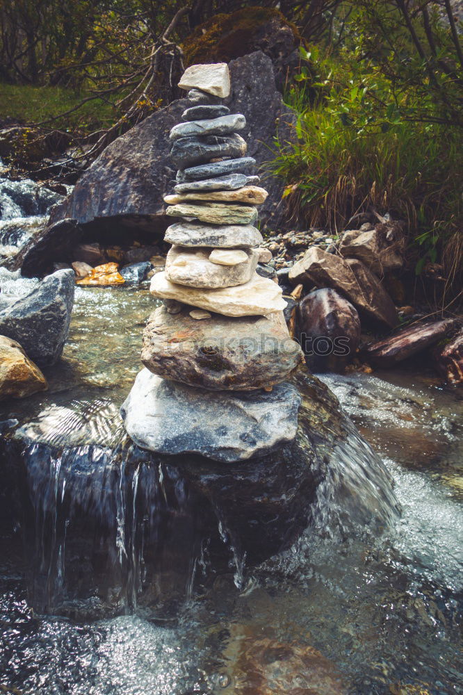 Similar – Boy sitting on a rock on mountain trail