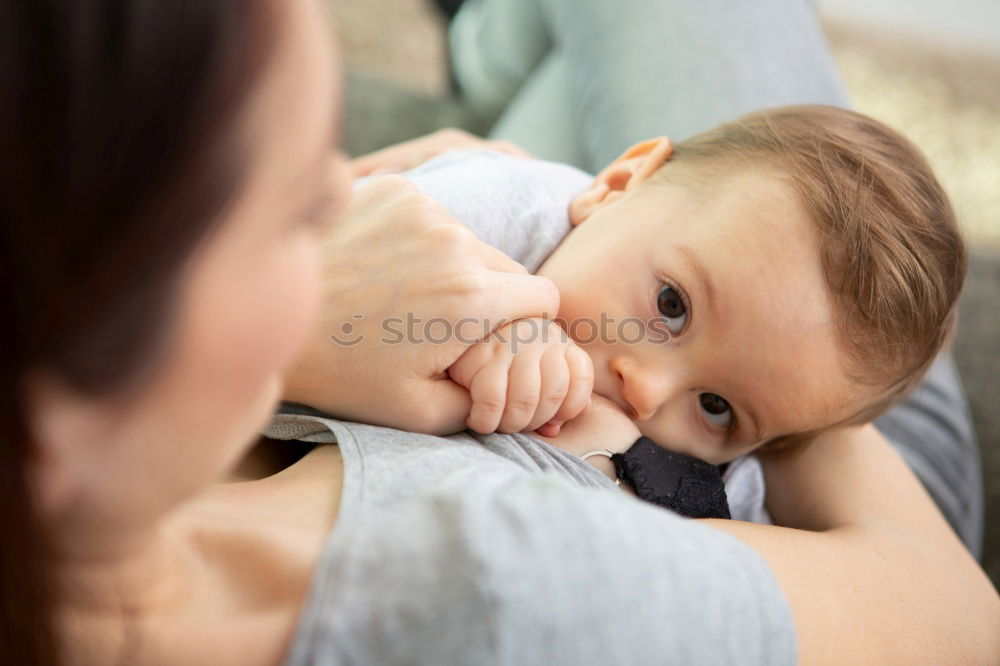 Similar – Image, Stock Photo Young mother breast feeding her baby at home