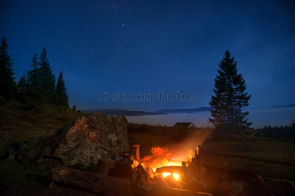 Similar – Image, Stock Photo Man lights a fire in the fireplace in nature at night