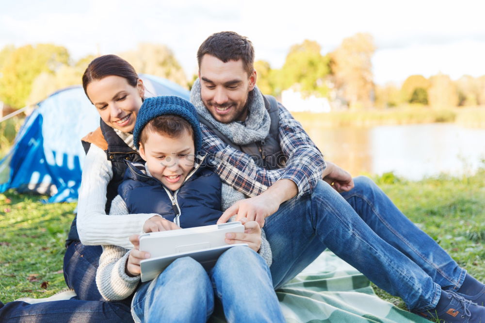 Similar – Young happy couple using smart phone sitting in the park