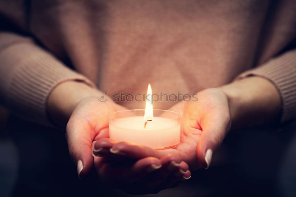 Similar – A single red burning candle held by a girl