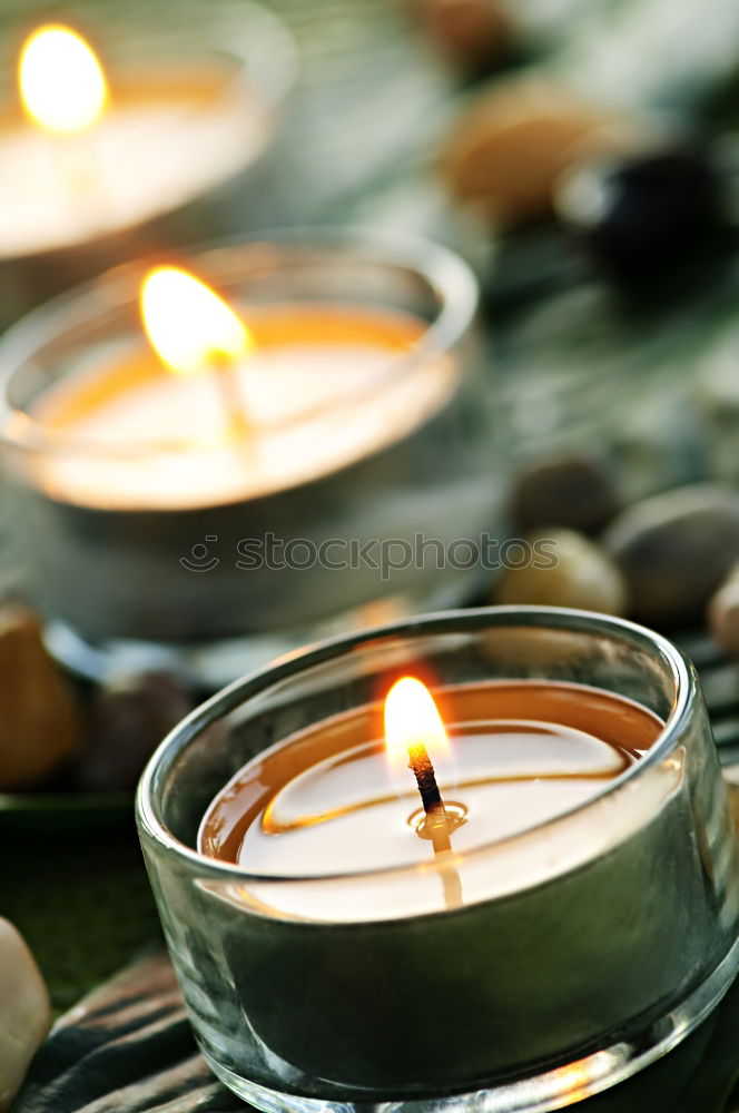 Similar – Image, Stock Photo Burning candle in a candle glass on a light wooden background. Weak depth of field