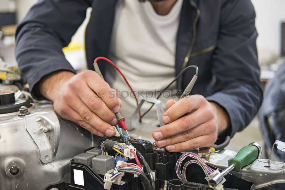 Similar – Professional Mechanic Repairing Car.