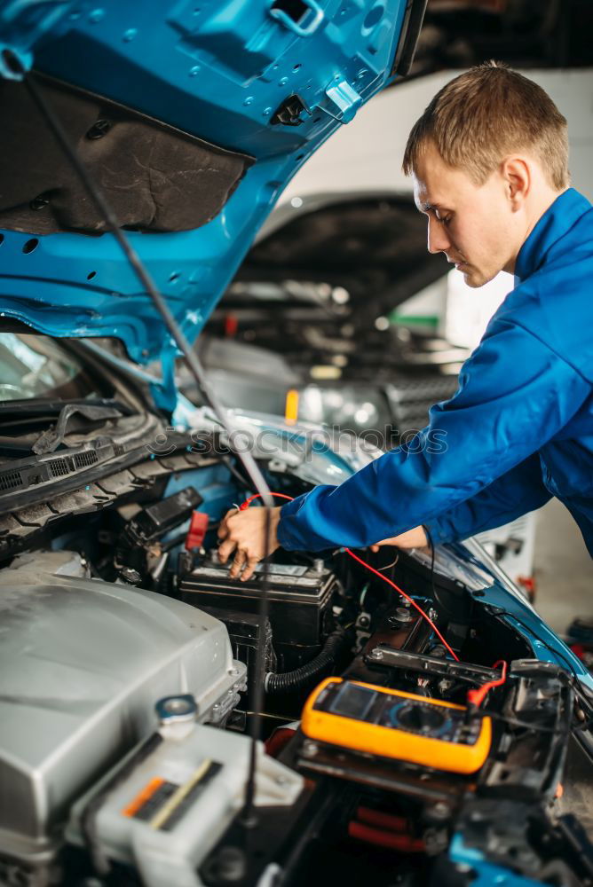 Similar – Professional Mechanic Repairing Car.