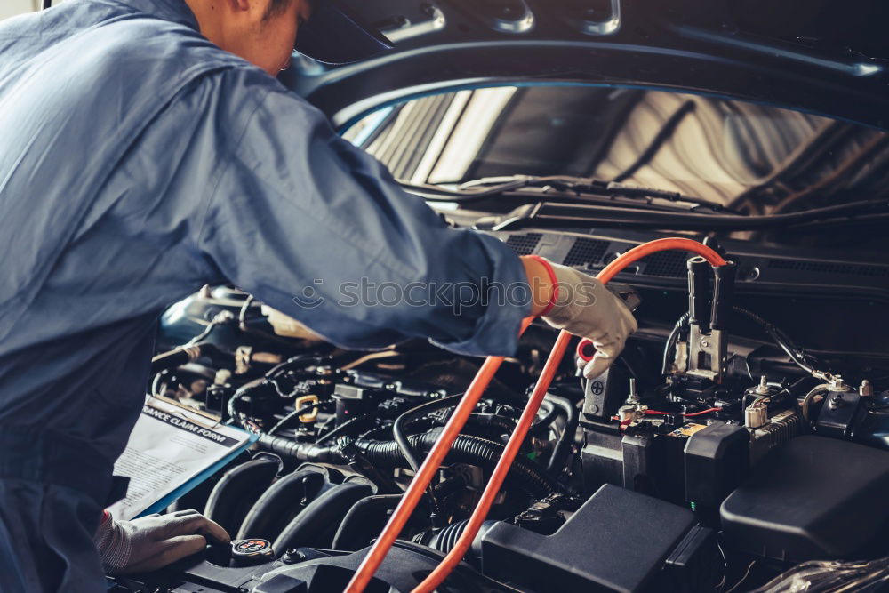 Similar – Professional Mechanic Repairing Car.