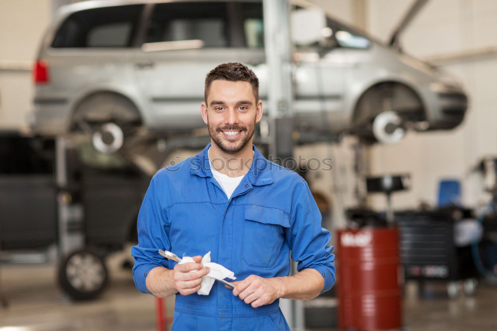 Similar – Image, Stock Photo Mechanic checking wheel of a customized motorcycle