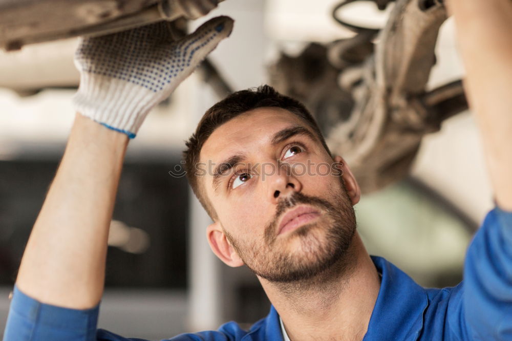 Professional Mechanic Repairing Car.