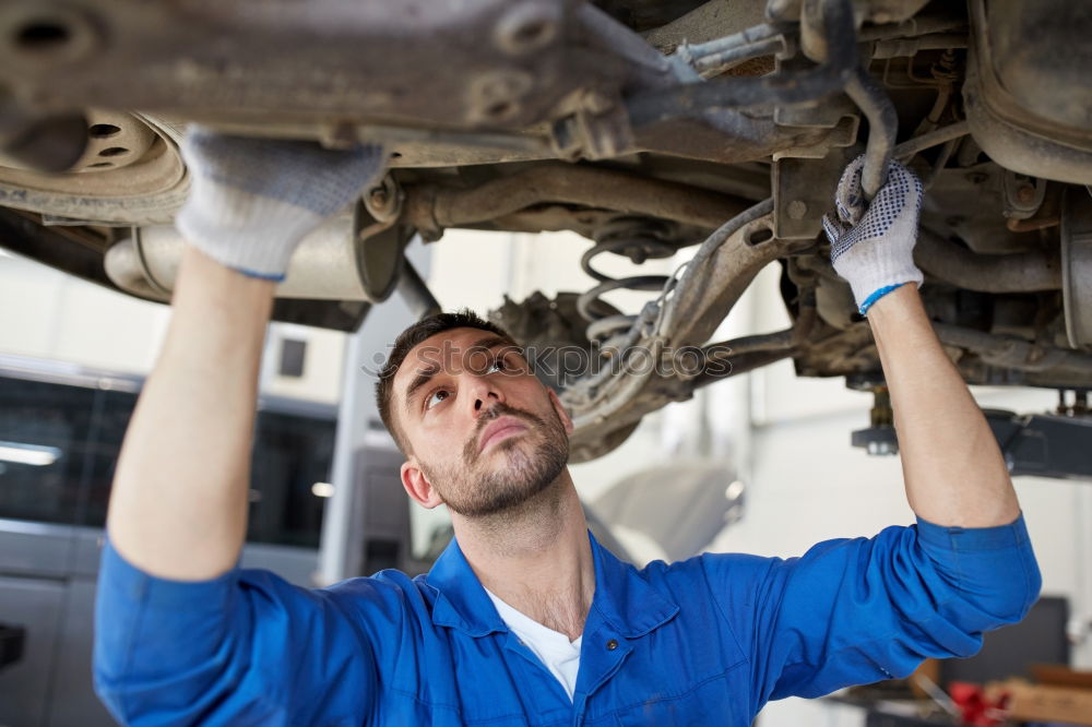 Similar – Professional Mechanic Repairing Car.