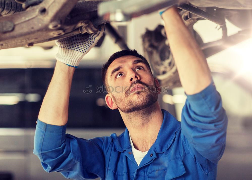 Similar – Professional Mechanic Repairing Car.