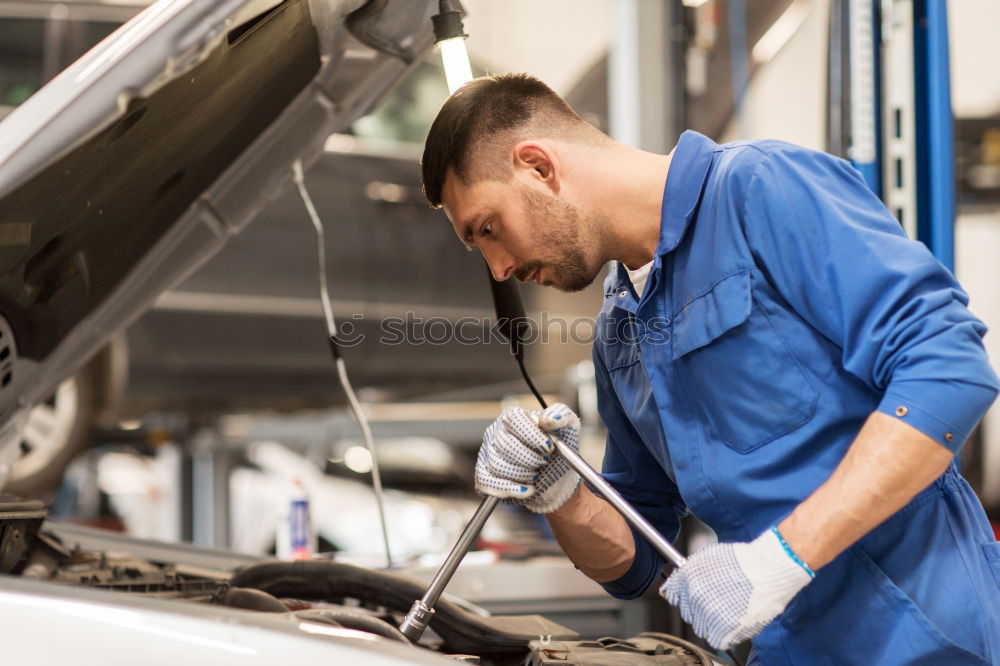 Similar – Professional Mechanic Repairing Car.