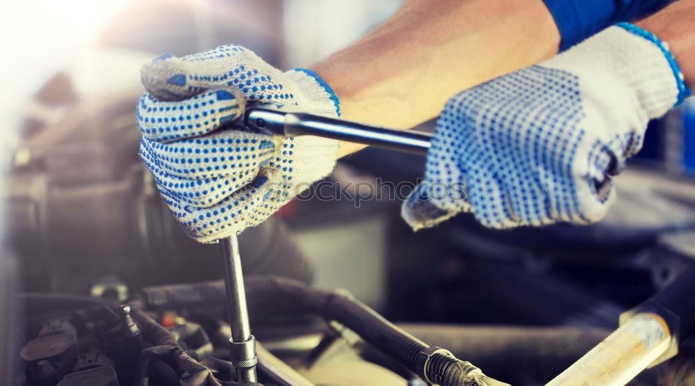 Similar – Professional Mechanic Repairing Car.