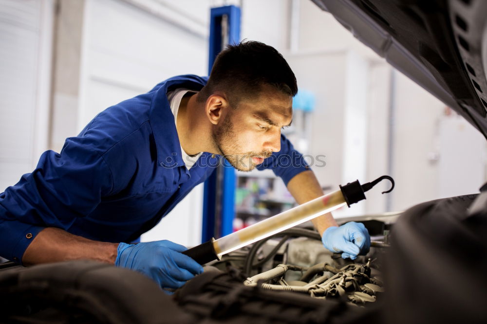 Similar – Professional Mechanic Repairing Car.