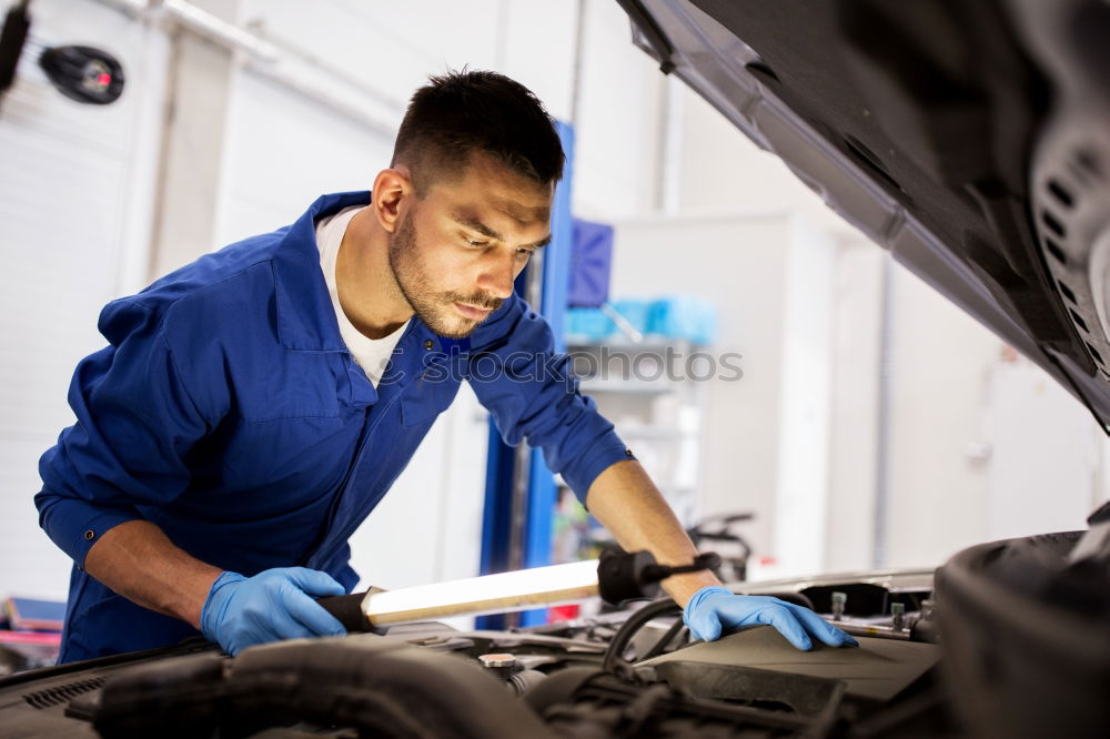 Similar – Professional Mechanic Repairing Car.