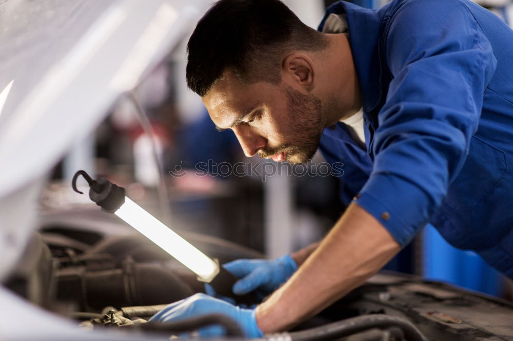 Similar – Professional Mechanic Repairing Car.