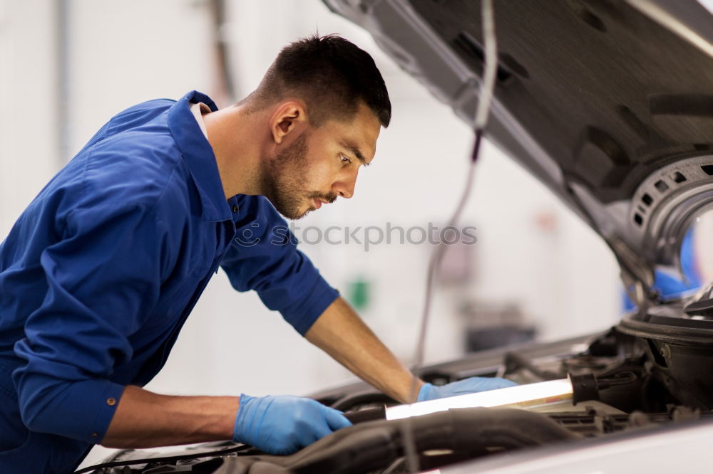 Similar – Professional Mechanic Repairing Car.