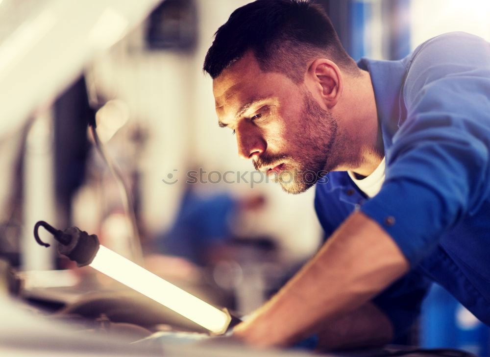 Professional Mechanic Repairing Car.