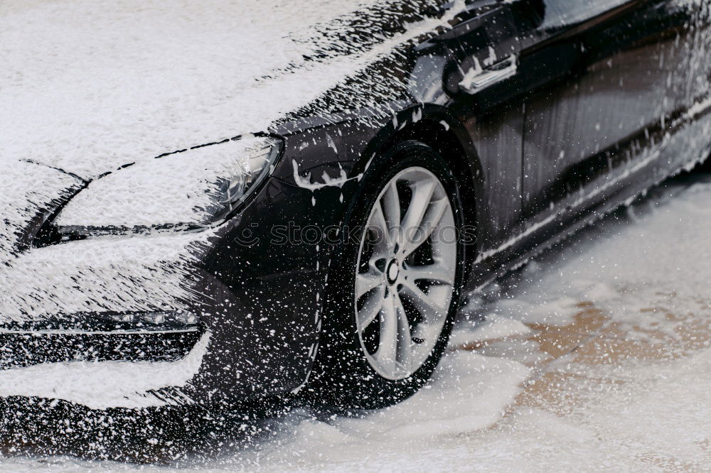 Similar – Whoosh!!! There thunders the dark car full through a deep puddle. A huge shower of water drenches the pedestrian with a colorful umbrella and red rubber boots.