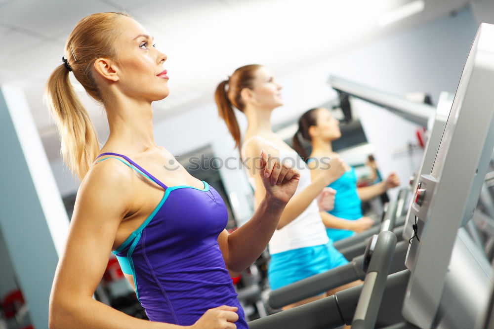 Similar – Woman drinking water while training on treadmill