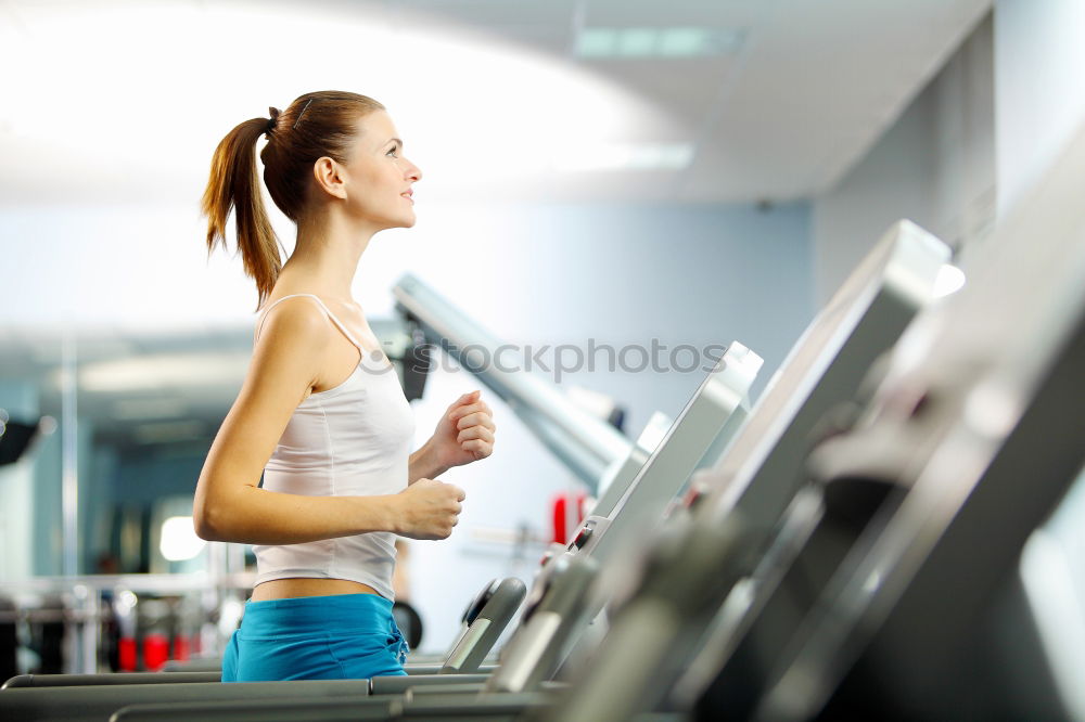 Similar – Image, Stock Photo Attractive Woman with headphones on treadmill in the gym